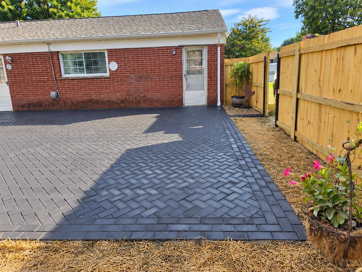 Herringbone paver patio and wood privacy fence
