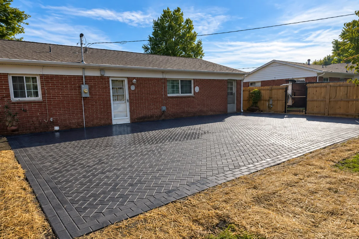 Wide view of a backyard paver patio